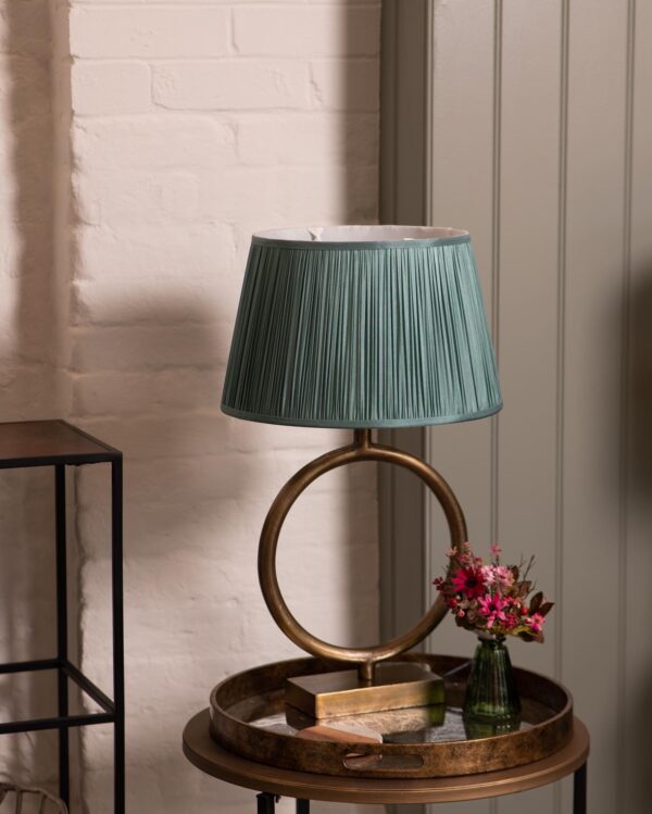 brass round lamp base with green pleated shade