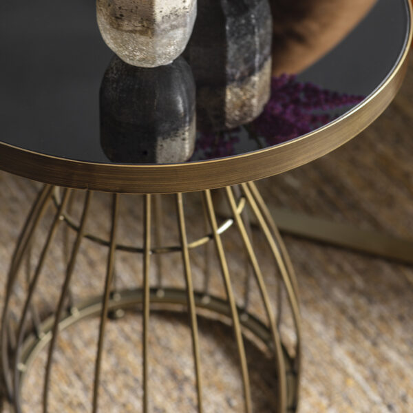 This decorative side table has a bronze powder coated caged frame with a inlaid white marble top